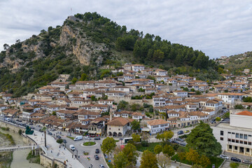 Aerial view of the historic Mangalem Quarter in Berat, Albania, with hillside homes and the castle rising above the old town.