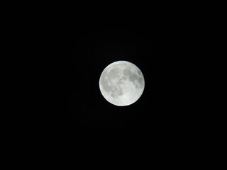 Genova, Italy - 07/09/2025: An amazing photography of the full moon over the city of Genova by...