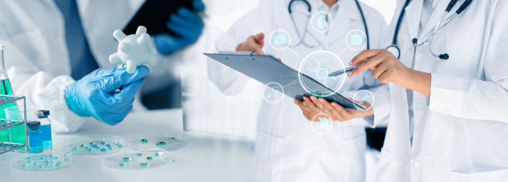 Doctor looking at x ray image and test tube of clear solution in a lab, healthcare and medical technology concept.