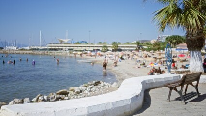 Seaside promenade and sunlit beach softly defocused outdoor; background backdrop copyspace backplate.
