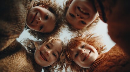 Group of joyful children huddling and smiling, looking down at camera from low angle, showing diverse friendship and cheerful togetherness
