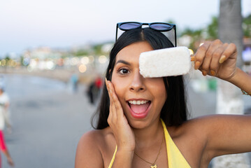 Happy mexican woman holding popsicle on puerto vallartaa boardwalk