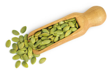 Peeled pumpkin seeds in wooden scoop isolated on white background. Top view. Flat lay