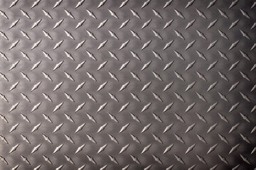 dark steel background. rhombic texture on a metal plate.