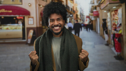 Man joyfully celebrating on a vibrant city street, surrounded by shops and people, capturing a moment of excitement and triumph.