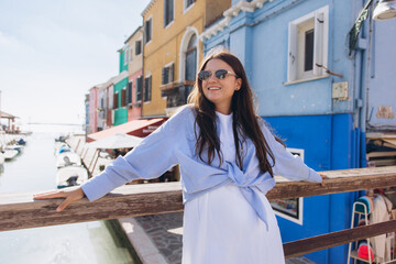 Woman traveling Burano island enjoying Venice views