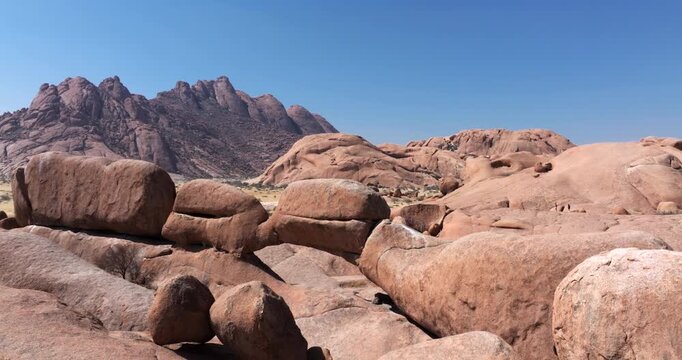 Aerial drone shot flying through the rock arch at Spitzkoppe in the Namib Desert of Namibia.