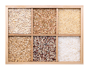 Common types of grains in wooden box. Six types of raw dried grains, in the upper row pearl barley, hulled buckwheat, and pearl millet, in the bottom row oat, quinoa seeds, and short-grain rice. Photo