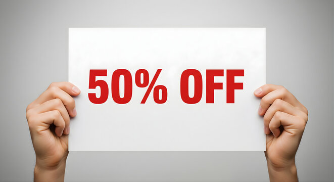 Hands holding 50 percent off sign concept of promotional discount sale for marketing offers and attracting customers to retail stores for limited time deals
