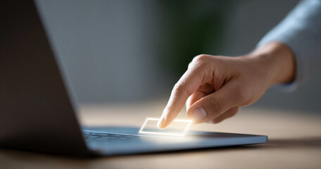 Close-up of a hand interacting with a glowing virtual touchpad on a laptop keyboard in a modern workspace environment
