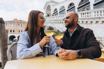 Couple drinking wine enjoying romantic date in Venice