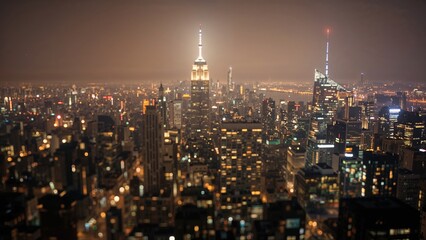 Night cityscape of New York City from above with lights illuminating the skyline. Urban scene, nighttime, city lights. The city that never sleeps, night view, metropolis.