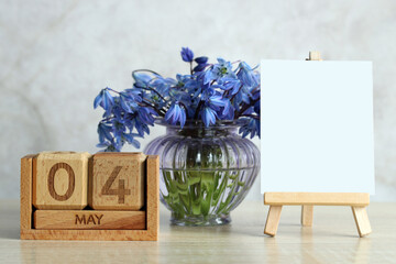 May 4th calendar with blue flowers and blank easel