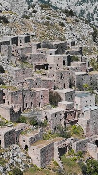 Ghost town Anavatos with ruined buildings on cliff on Chios island, Greece