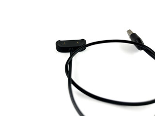 Top View of Black Smartwatch Charging Cable on White Background, Modern Accessory