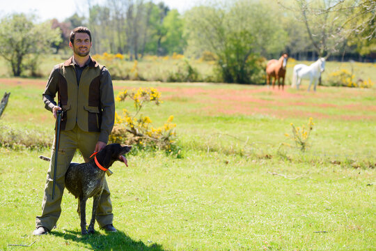 picture of a male hunter and his dog