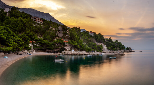 Croatia, Dalmatia, the Adriatic coast at sunrise, with the Biokovo Mountains and forests in the background. The village of Brela is a summer resort on the Makarska Riviera.