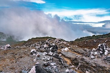 Vapour cloud rising from the geothermal, oxidized slopes under a striking blue sky at Poás...