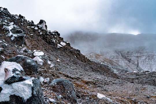 Steep, barren volcanic ridge overlooking the misty Poás Volcano crater area, Costa Rica. - Powered by Adobe