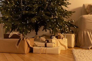 Christmas gifts under the tree with warm lighting in a cozy interior

