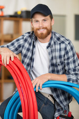 Naklejka premium technician holding water pipes indoors