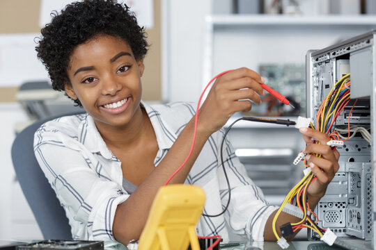 a female worker is fixing pc