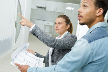 female interior designer giving instruction to foreman
