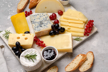 Italian and French gourmet cheese platter with craft cheese assortment on a marble platter. hard cheeses, mold cheese, gorgonzola, pecorino, Emmental, Roquefort cheddar