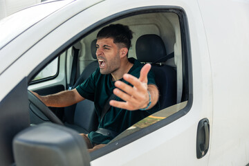 Latin man yelling, expressing anger while driving van