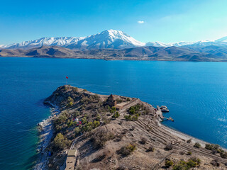 Vertical aerial photograph showcasing Akdamar Island's unique peninsula shape, the historic Holy...