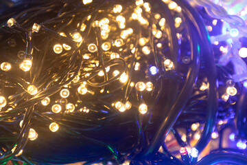 Twinkling fairy lights tangled in dark wires create a mesmerizing visual display, perfect for festive decorations and adding warmth to any environment during celebrations