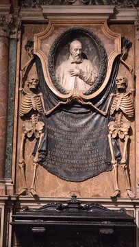 Rome, Italy &ndash; 11 January 2025. Tomb of Cardinal Edoardo Vecchiarelli in San Pietro in Vincoli, featuring skeleton sculptures holding a draped inscription beneath a marble bust.
