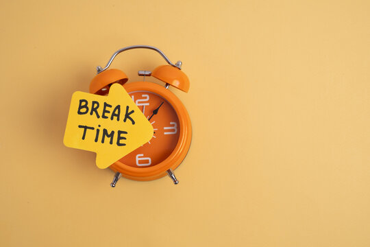 Bright orange alarm clock with "Break Time" sticky note. Timed Reminder.