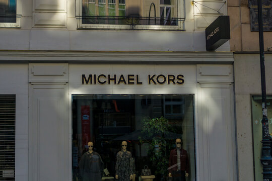 Vienna, Austria, Europe - Nov 08, 2025: michael kors luxury fashion boutique sign and storefront display with mannequins in vienna austria