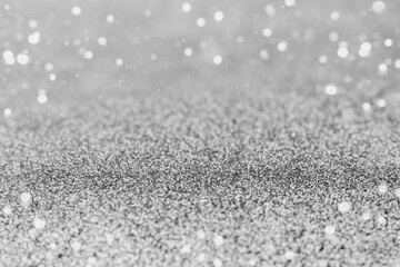 Obraz premium Shimmering silver glitter texture with bokeh lights for background and design projects