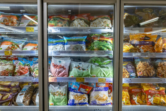 Valmier, Latvia - November 24, 2025: Frozen food display in supermarket showcasing a variety of packaged vegetables, fruits, and snacks, highlighting convenience and healthy options for consumers