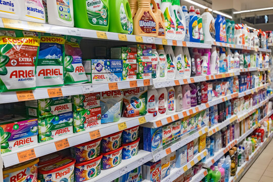 Valmier, Latvia - November 24, 2025: Colorful shelves filled with various laundry detergents and cleaning products in a supermarket aisle, showcasing popular brands and vibrant packaging