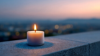 Single Candle Burning on a Stone Surface at Twilight with City Lights in Background