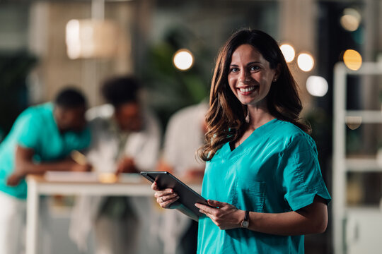 Female doctor nurse holding tablet smiling at camera - Powered by Adobe