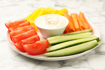 Different fresh vegetables and sauce on white marble table, closeup