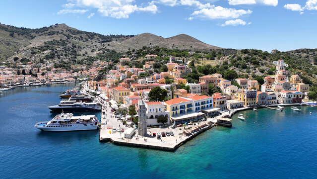 Aerial drone photo of picturesque seaside main town and port of Yialos of Symi island with colorful neoclassical houses and traditional character, Dodecanese, Greece - Powered by Adobe