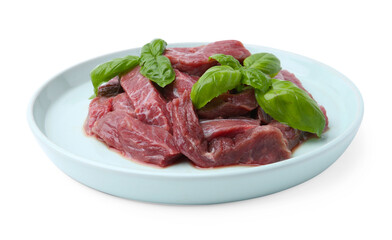 Pieces of raw beef meat and basil isolated on white