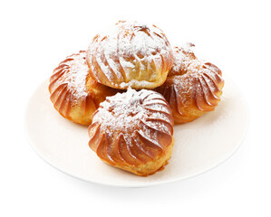 Tasty profiteroles with powdered sugar isolated on white