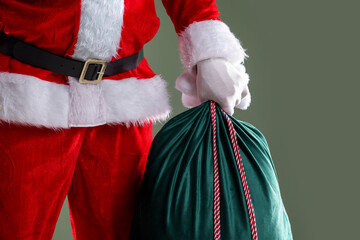 Santa Claus with sack on grey background, closeup. Merry Christmas and Happy New Year