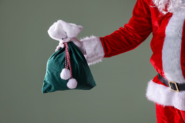 Santa Claus with sack on grey background, closeup. Merry Christmas and Happy New Year