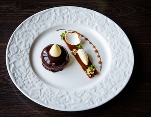 Elegant chocolate dessert with artistic presentation on textured white plate