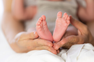 Parent holding baby feet showing love and care