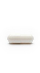 Single white capsule pill isolated on a white background