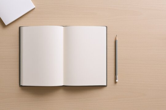 Open notebook with blank pages and pencil on a desk, ready for writing or sketching