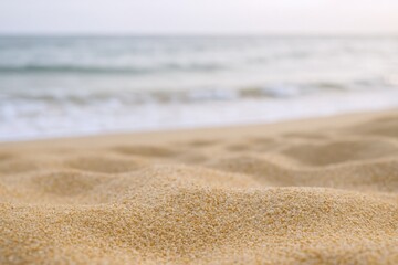Golden Sand Texture on a Serene Beach with Calm Ocean Waves in the Background